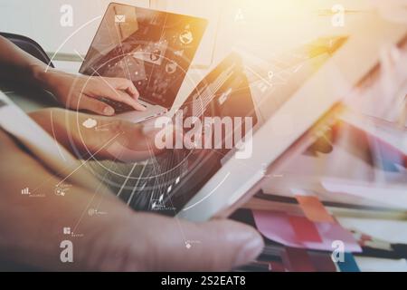 creative working with mobile phone and digital tablet and stylus pen on wooden desk in modern office with virtual icon diagram Stock Photo