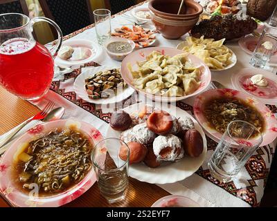 A dining table adorned with traditional dishes and beverages, highlighting cultural and festive culinary traditions of various cuisines, showcasing cr Stock Photo