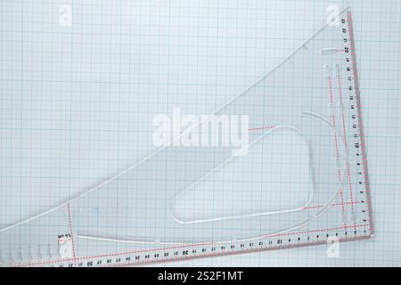 One sheet of graph paper with a plastic ruler, macro, top view. Stock Photo