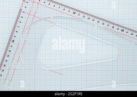 One sheet of graph paper with a plastic ruler, macro, top view. Stock Photo