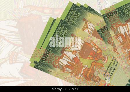 1000 Sri Lankan rupees bills lies in stack on background of big semi-transparent banknote. Abstract presentation of national currency. Business concep Stock Photo