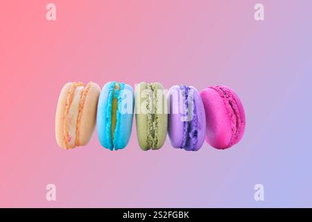 colorful macaroni on pink gradient background Stock Photo