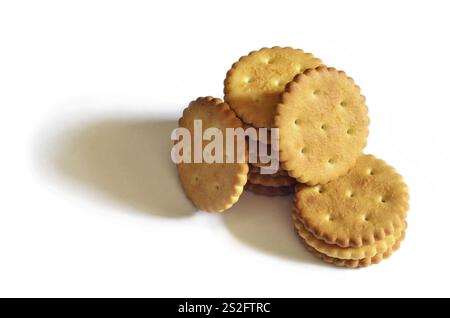 Classic round golden yellow salted cracker isolated on over white background Stock Photo