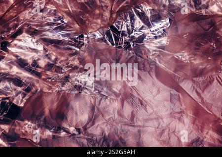 Texture of glossy polyethylene plastic sheet material crumpled and wrinkled from above Stock Photo
