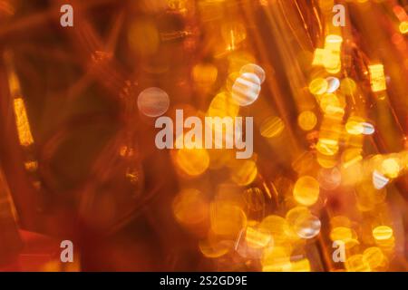 Warm golden bokeh with circular highlights, creating an abstract, festive, and cozy ambiance. Background Stock Photo