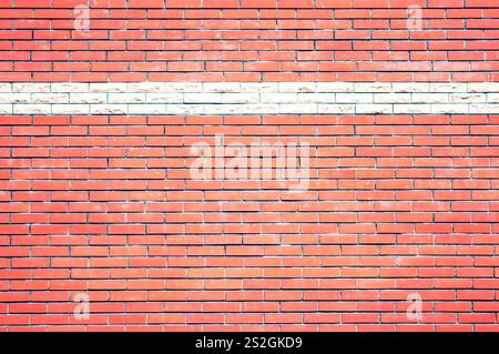 A brick wall is a sturdy structure made of bricks and mortar. It provides privacy, security, and aesthetic appeal to buildings. durability and timeles Stock Photo