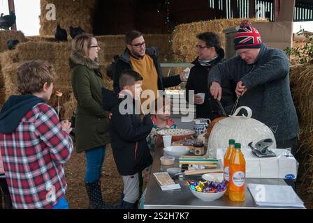 Farm Open Day agriculture in the UK. Free range turkeys, Christmas birds. Young farmer Jacob Sykes carving a roasted turkey for the farm visitors to taste. British agriculture food production visitors shown around Fosse Meadows Farm, North Kilworth Leicestershire England. November 2016 2010s  HOMER SYKES Stock Photo