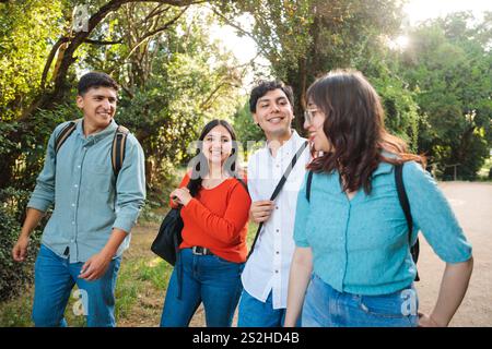 Happy university students walking and talking in the park Stock Photo