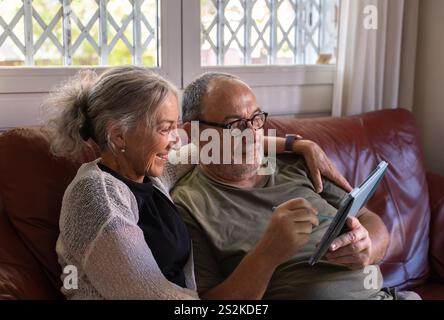 The concept of older marriage learning new technologies Stock Photo
