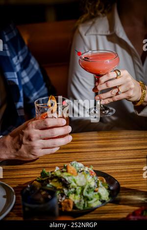Hands holding cocktail glasses Stock Photo