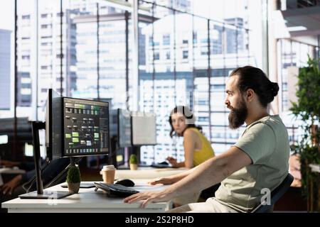 Full stack developer conducting experiments and tests to optimize machine learning models for performance and accuracy. IT expert in modern office analyzing and interpreting complex data Stock Photo
