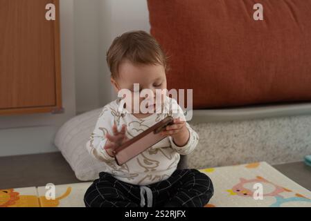 10 month-old baby using phone Stock Photo