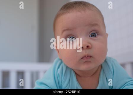 Baby lying on his stomach waking up Stock Photo