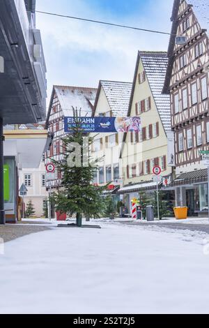 Snow-covered street with half-timbered houses and Christmas tree in typical town view, Nagold, Black Forest, Germany, Europe Stock Photo