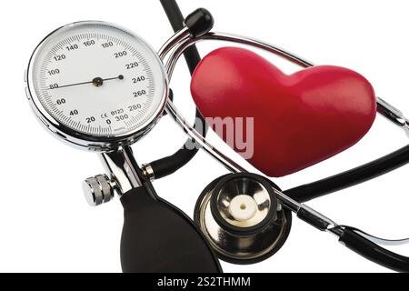A sphygmomanometer, a heart and a stethoscope lie on a white background Austria Stock Photo
