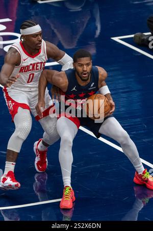 Houston Rockets guard Aaron Holiday controls the ball during an NBA ...