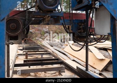 Close-up of a machine for sawing pine logs at a sawmill Stock Photo