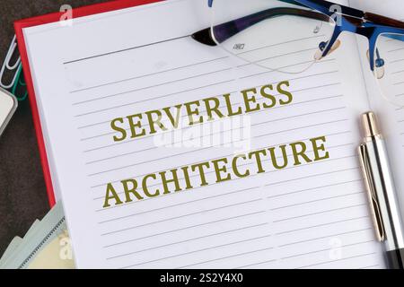 Concept words SERVERLESS ARCHITECTURE it is written in the business book in close-up, top view. Stock Photo