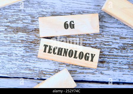 Wooden blocks marked with the text 6G technology rest on a rustic wooden surface, emphasizing the emerging advancements in wireless communication syst Stock Photo