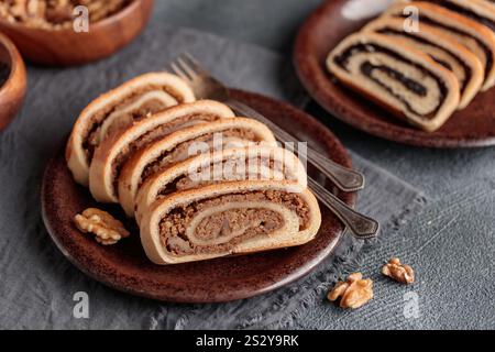 Home baked roll, bejgli in slices, traditional Hungarian sweet bread stuffed with walnut and poppy seed filling. Eastern European Christmas and Easter Stock Photo
