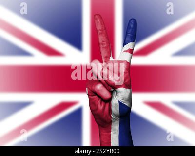Male hand with victory sign in front of Great Britain flag Stock Photo