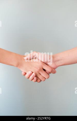 2 hands shaking hands on an isolated white background Stock Photo