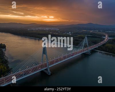 Aerial view of a modern cable-stayed bridge spanning over railway ...