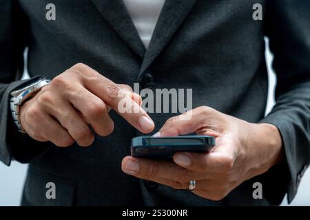 Businessman hands using smartphone for business Stock Photo