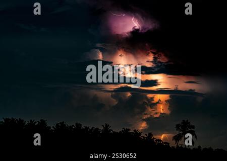 Thundering and Lightning Striking Through the Night Rainy Sky in a Dramatic Scene Stock Photo