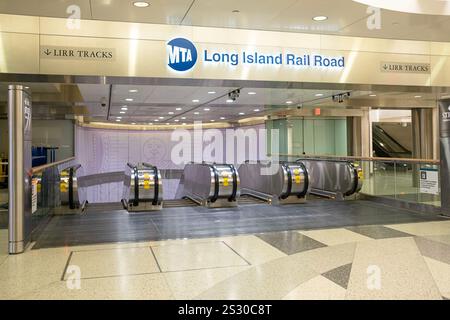 The stairs & escalator to the Long Island Rail Road train platforms in the Grand Central Hudson part of Grand Central Staton in Midtown Manhattan, NYC. Stock Photo