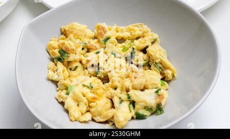 Scrambled eggs on white stone background. Close-up view Stock Photo