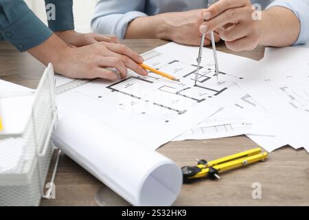 Architects working with project, closeup. Different technical drawings on wooden table Stock Photo