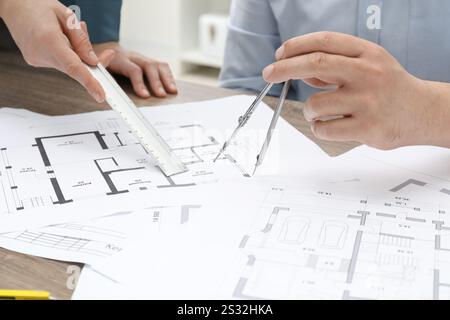 Architects working with project, closeup. Different technical drawings on wooden table Stock Photo