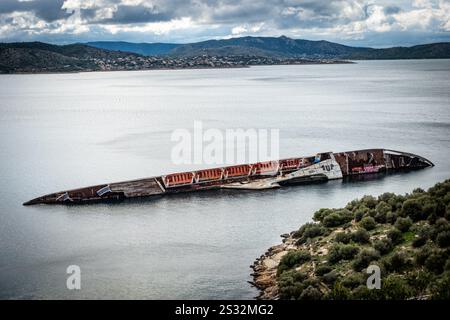 A large ship is calmly floating on the surface of an expansive and vast body of water, enjoying the tranquility of its surroundings Stock Photo