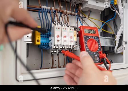 Hands Testing Electrical Circuits with Multimeter Stock Photo