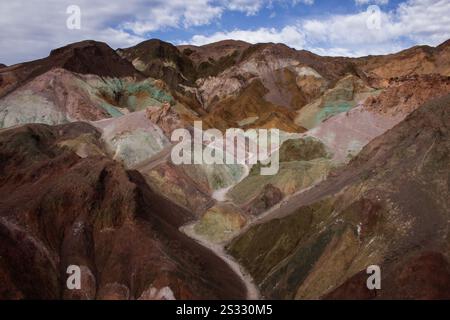 A trail winds through the colorful pink, purple and green hills in Artist’s Palette in Death Valley National Park in California. Stock Photo