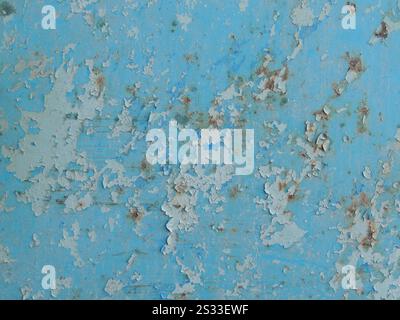 fragment of iron painted surface with peeling blue paint as background grunge texture, peeling paint on wall with flakes and cracks in structure Stock Photo