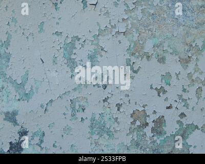 peeling paint on concrete wall, flaking building surface, weathered texture with paint flakes as antique grunge background Stock Photo