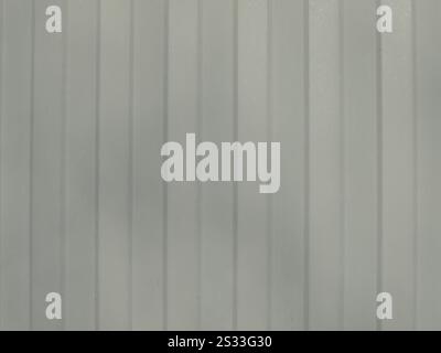 gray textured background with vertical stripes and softened sharpness, fragment of galvanized metal sheet with convex grooves, part of iron fence Stock Photo