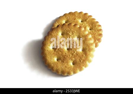 Classic round golden yellow salted cracker isolated on over white background Stock Photo