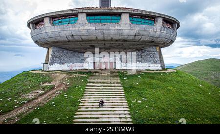 A magnificent large building is prominently sitting atop a picturesque hill, complete with a series of stairs leading up to its grand entrance Stock Photo