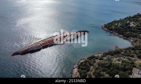 An expansive aerial view capturing a large ship gracefully positioned in the middle of the vast ocean, surrounded by water and waves Stock Photo
