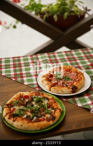 Delicious pizza served on wooden table with green plaid tablecloth. Italian cuisine concept, traditional pizza recipe. Stock Photo