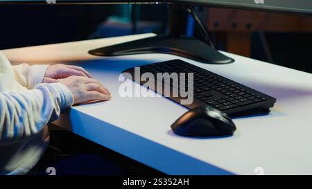 Teleworking computer technician typing on keyboard, implementing security measures to protect company systems and data, close up. Remote IT employee at home debugging code for software, camera A Stock Photo