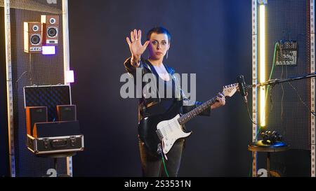 Female performer showing stop sign with palm, doing serious break ...