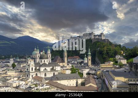 Panorama of Salzburg's historic city centre at dusk with Hohensalzburg Fortress and dramatic clouds, Salzburg, Salzburger Land, Austria, Europe Stock Photo