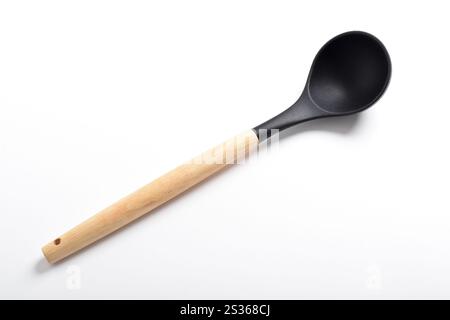 Black silicone kitchen soup ladle isolated on white background. Kitchen utensils Stock Photo