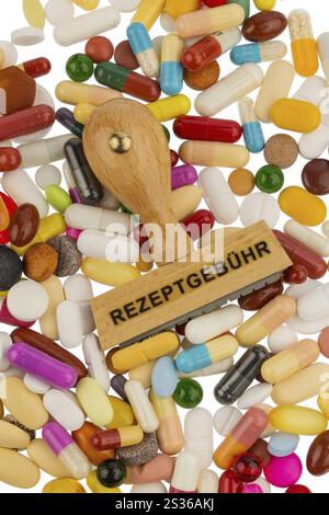 Stamp on coloured tablets, symbol photo for medication, prescription requirement and co-payment Stock Photo
