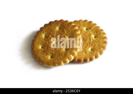 Classic round golden yellow salted cracker isolated on over white background Stock Photo