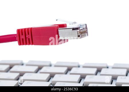 Network cable on keyboard, symbolic photo for flat rate, e-commerce, global communication Austria Stock Photo
